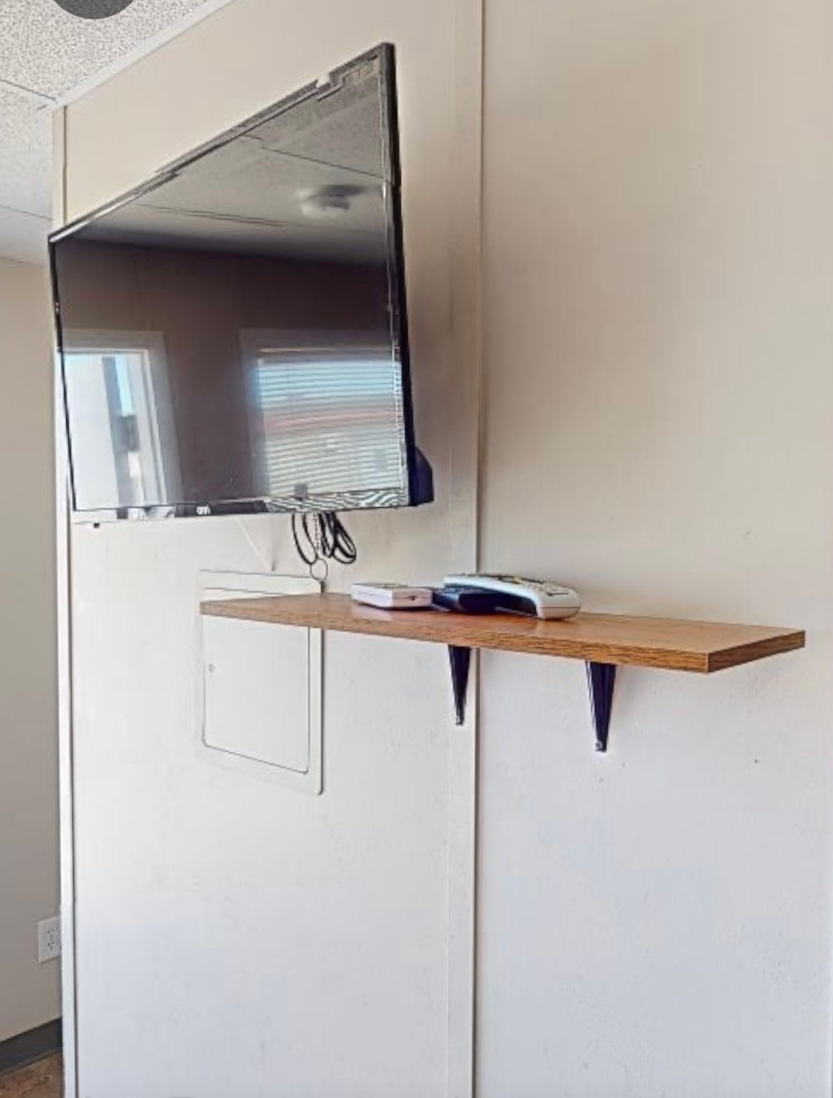 Wall-mounted TV with shelf